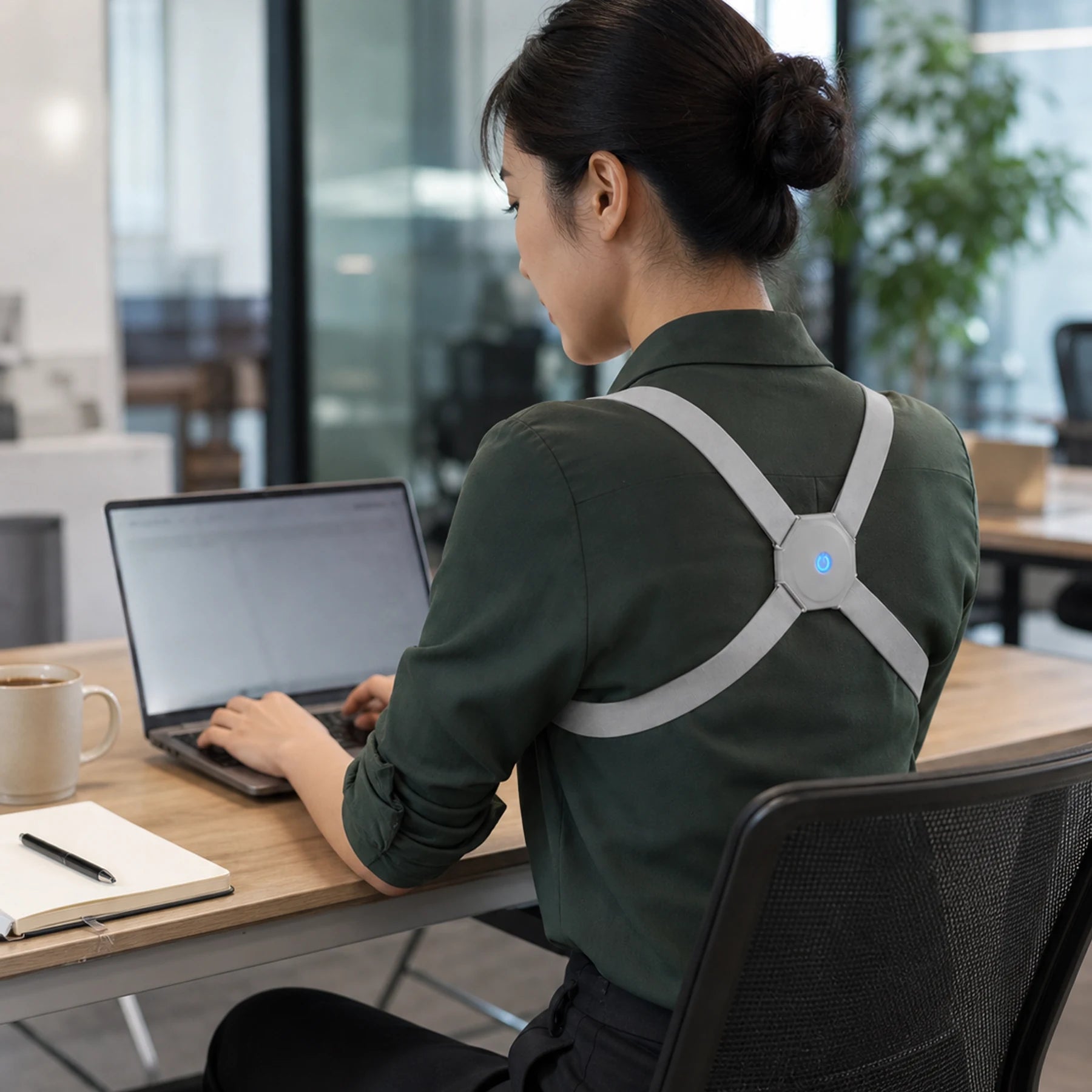 Office professional wearing AlignNova at a modern workstation